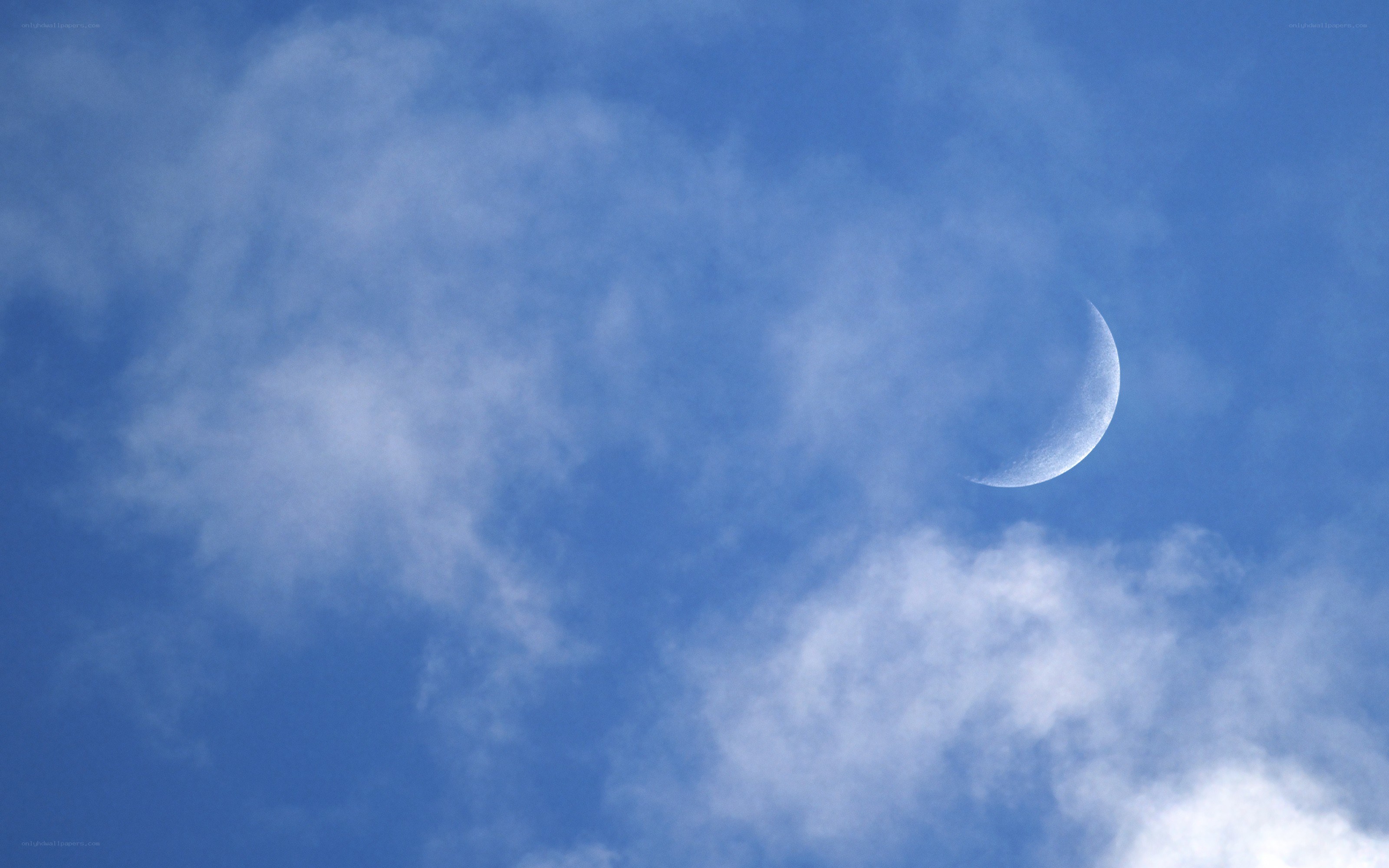 Crescent moon in blue sky
