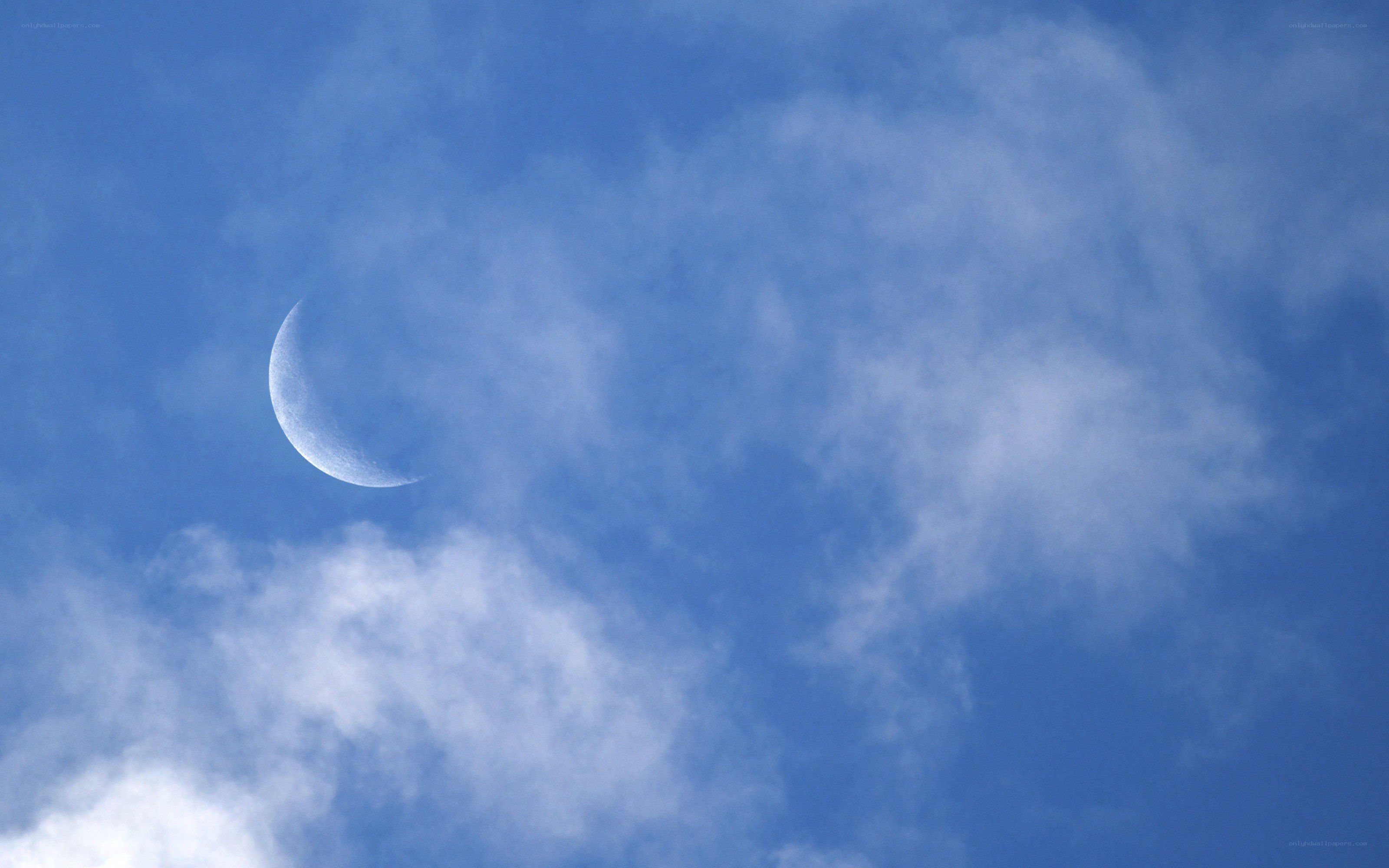 Crescent moon in blue sky