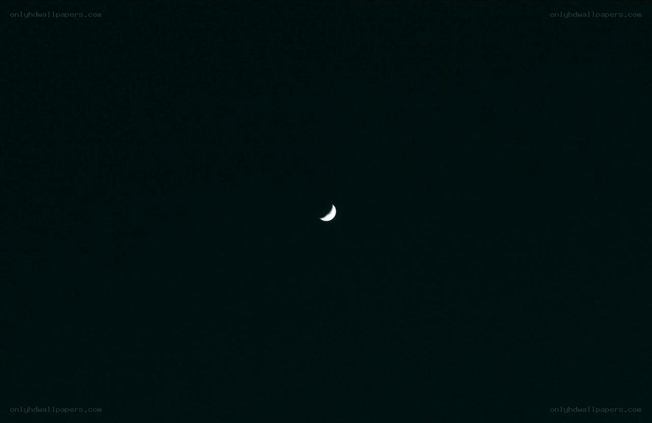 Crescent moon in dark sky