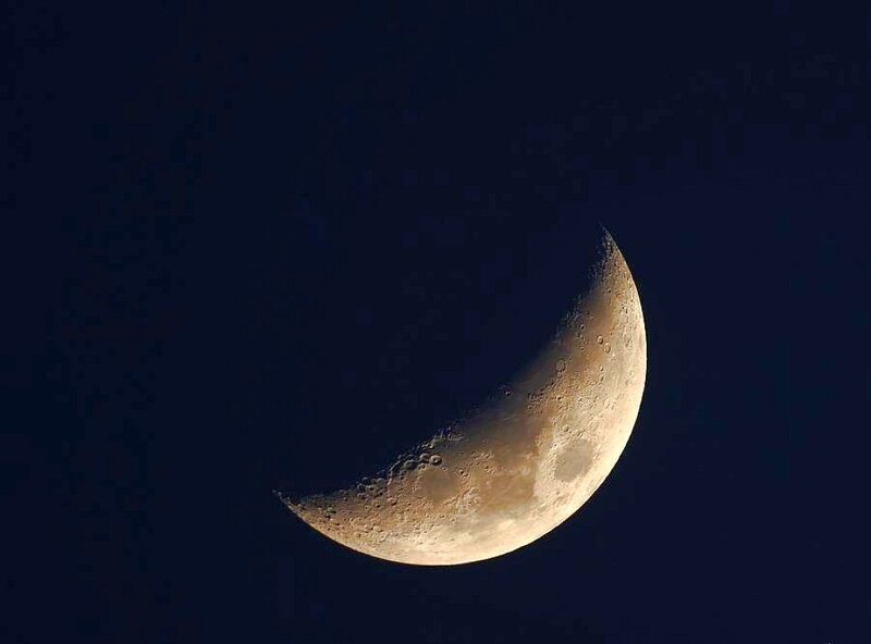 Crescent moon in night sky
