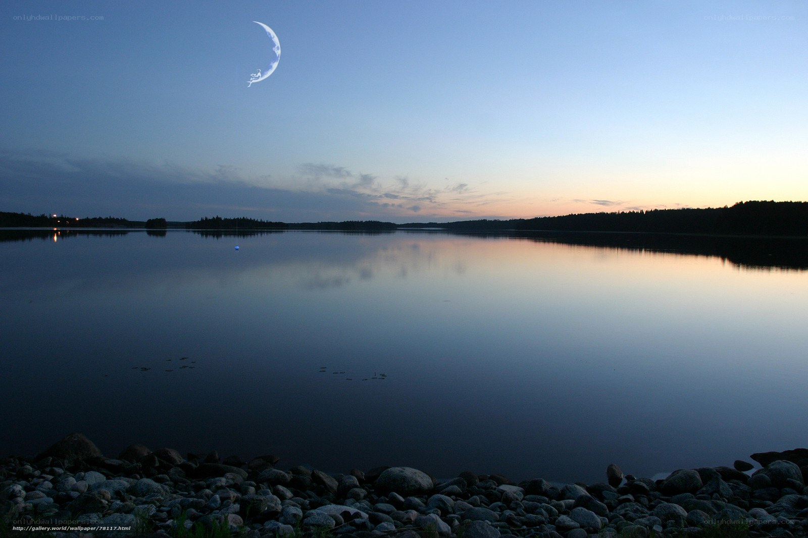 Crescent moon over calm lake