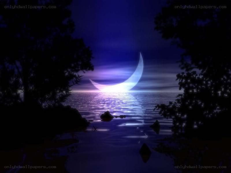 Crescent moon over calm water