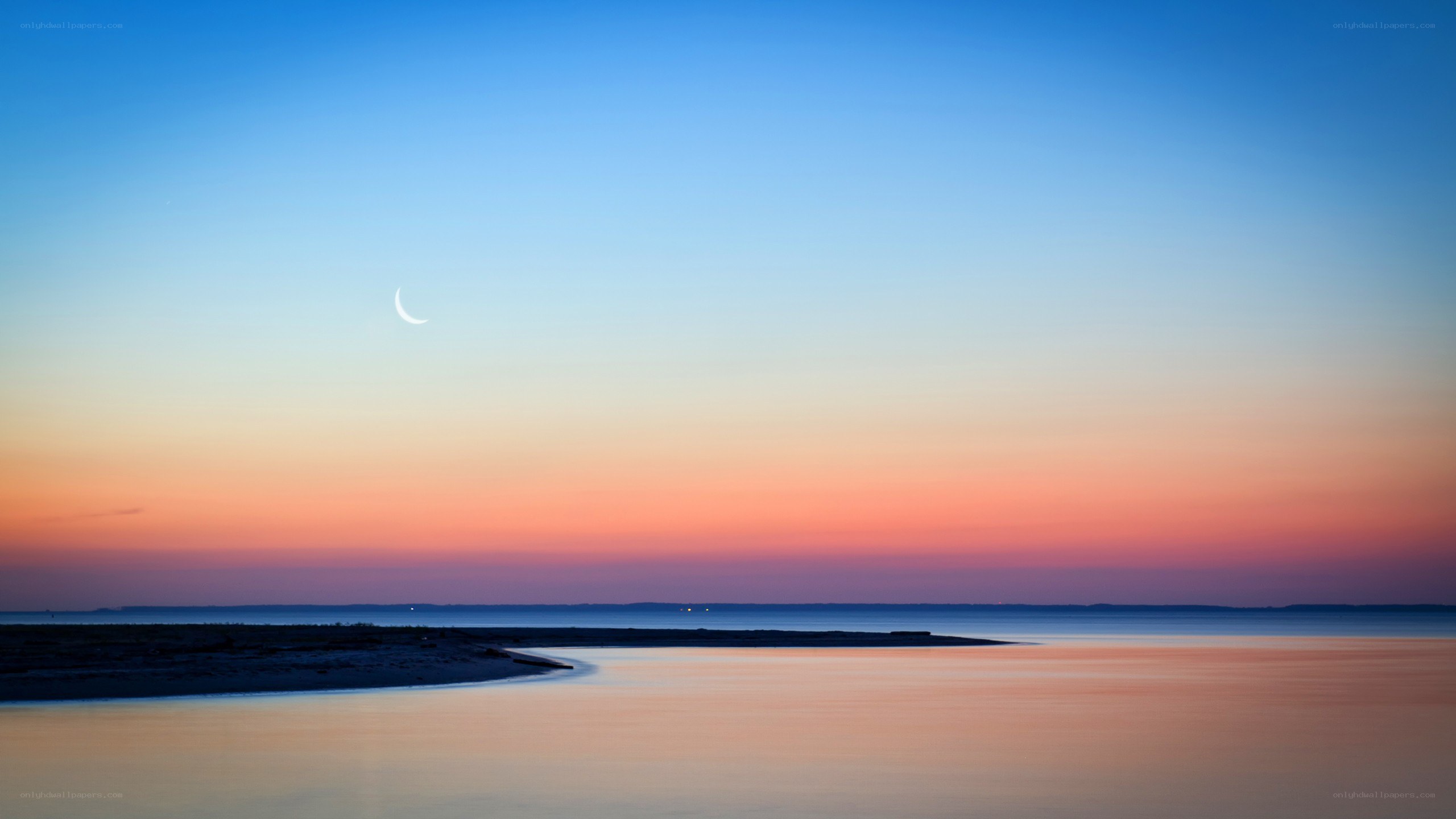Crescent moon over coastal waters