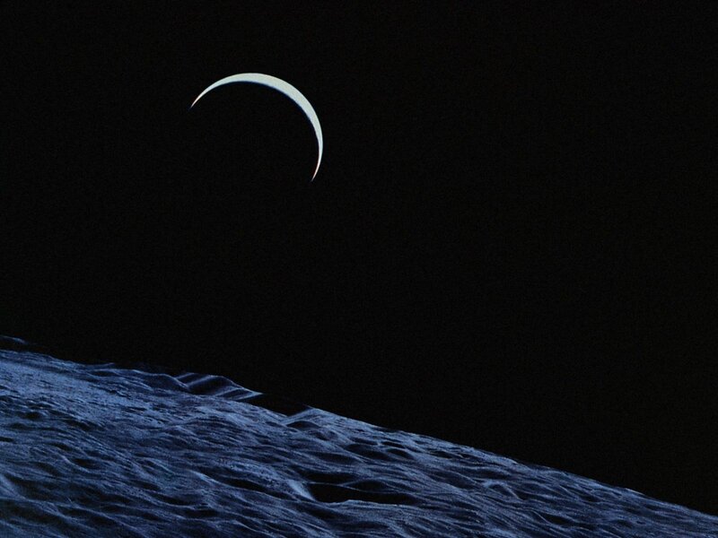 Crescent moon over lunar surface