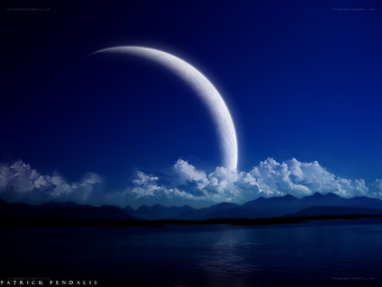Crescent moon over mountains