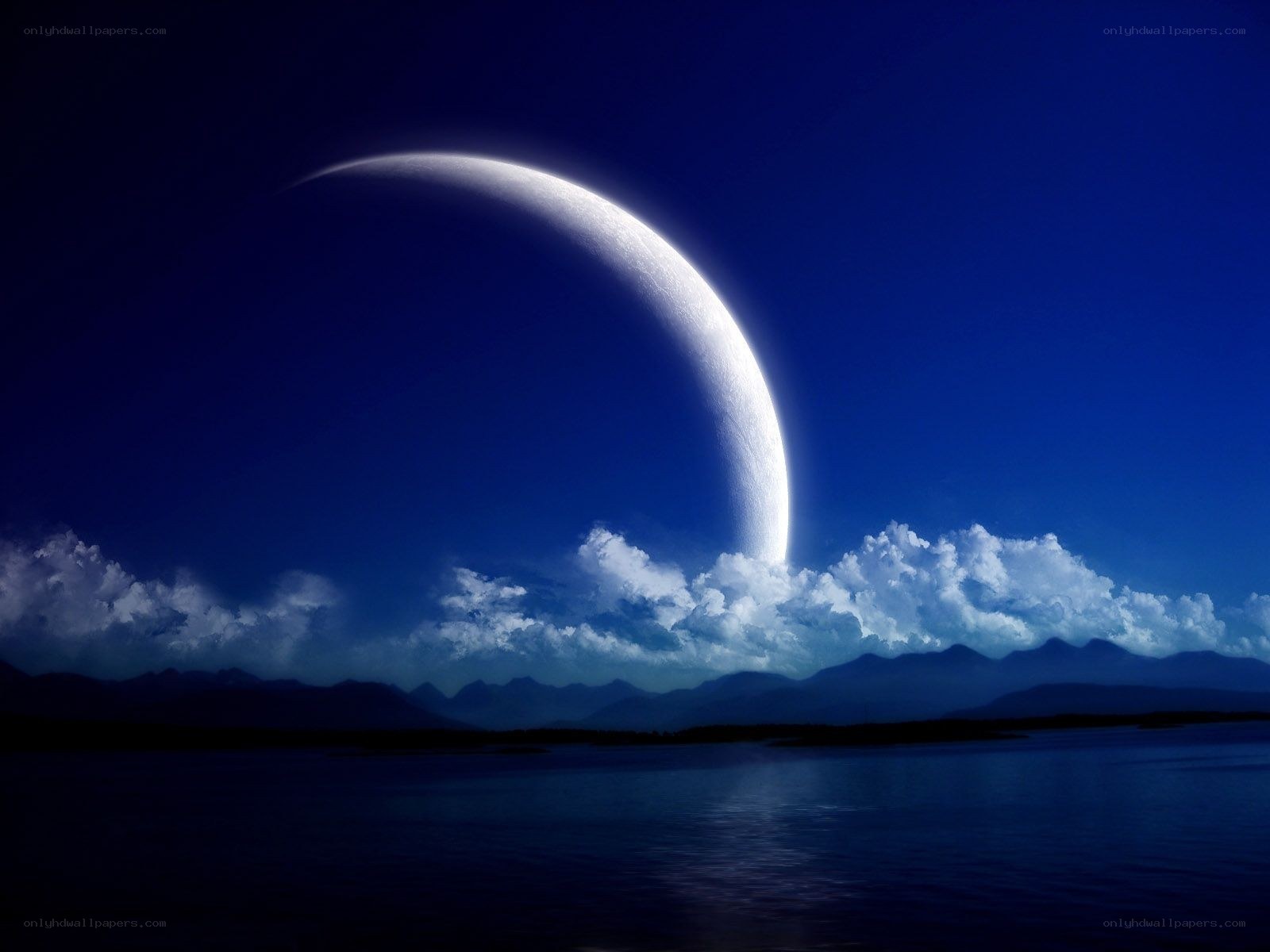 Crescent moon over mountains