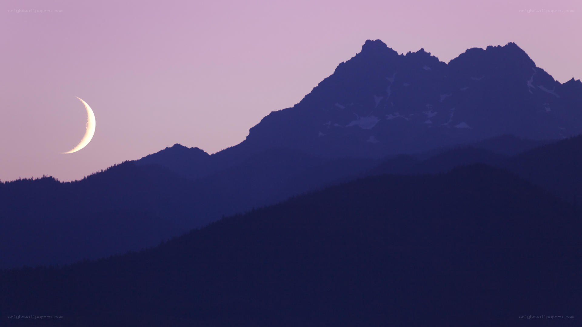 Crescent moon over mountains