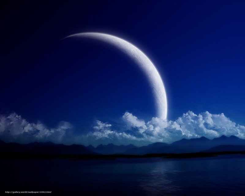Crescent moon over mountains