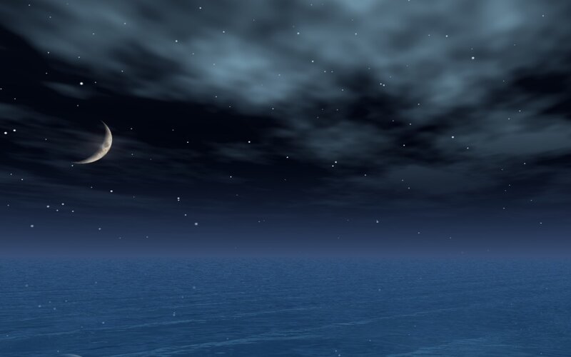 Crescent moon over ocean