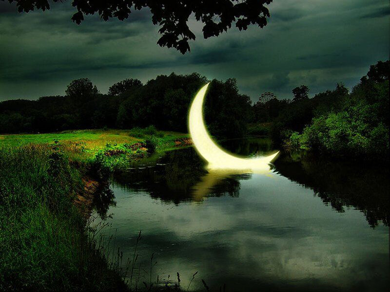 Crescent moon over river