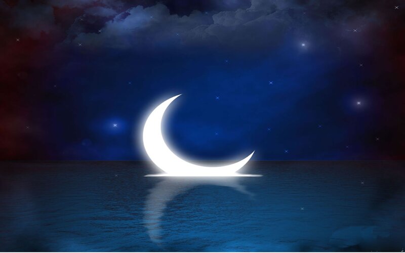 Crescent moon over water