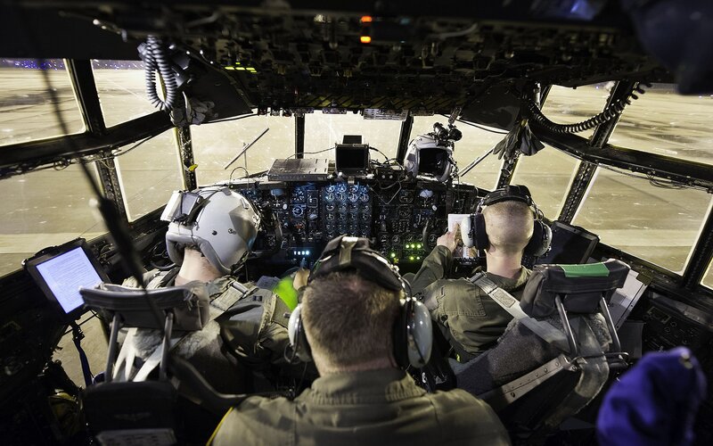 Crew in aircraft cockpit at night