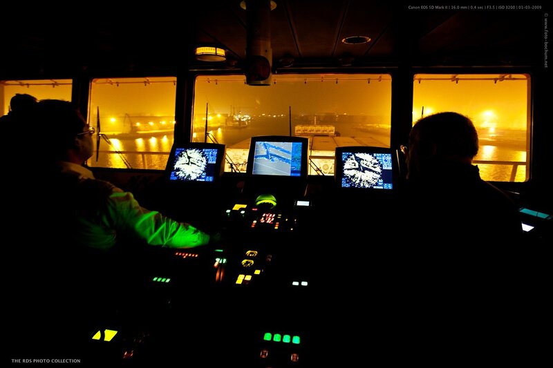 Crew in ship's bridge at night