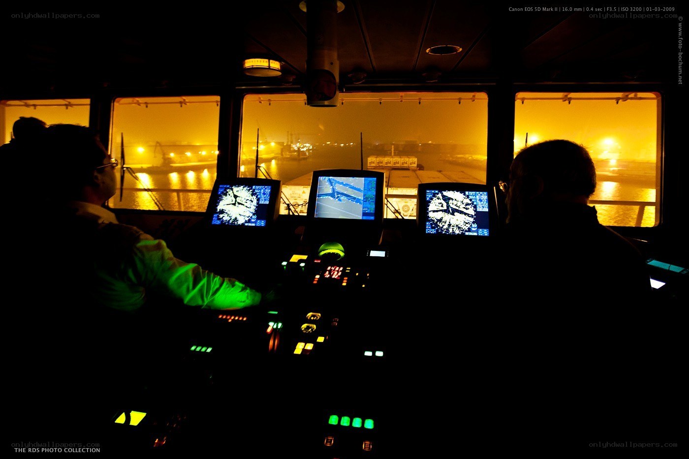 Crew in ship's bridge at night