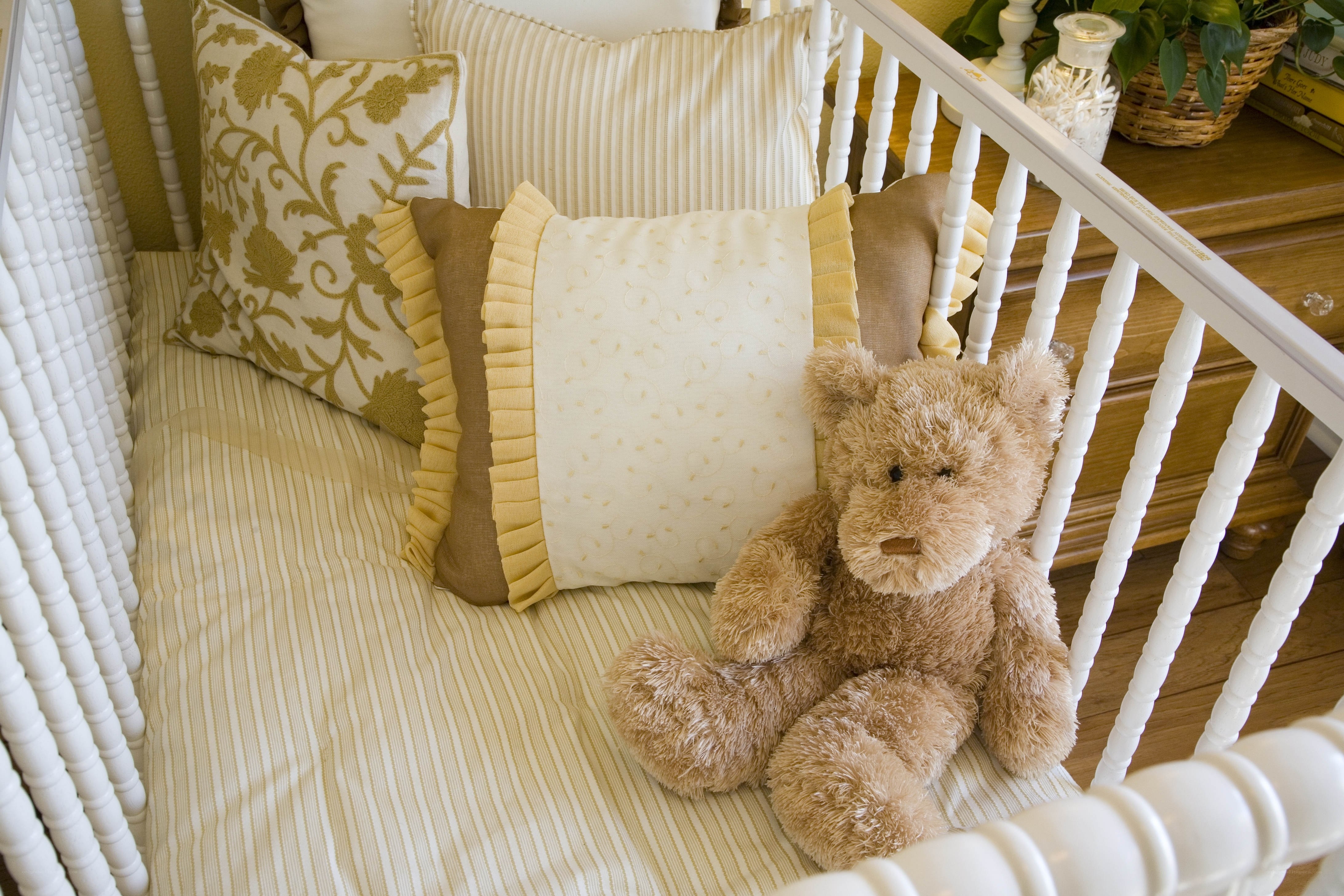 Crib with teddy bear and pillows