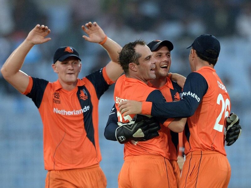 Cricketers Celebrating — Orange, Celebratory, Photograph
