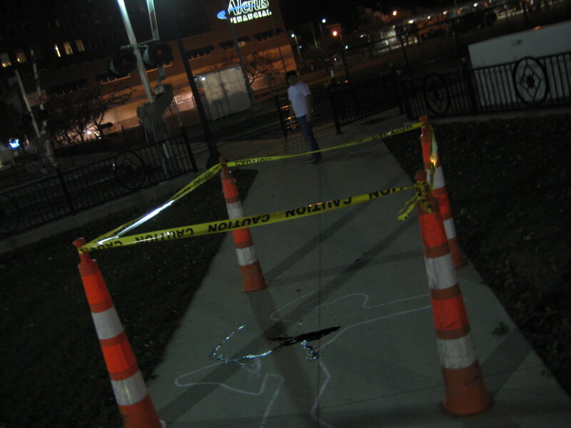 Crime scene tape on sidewalk
