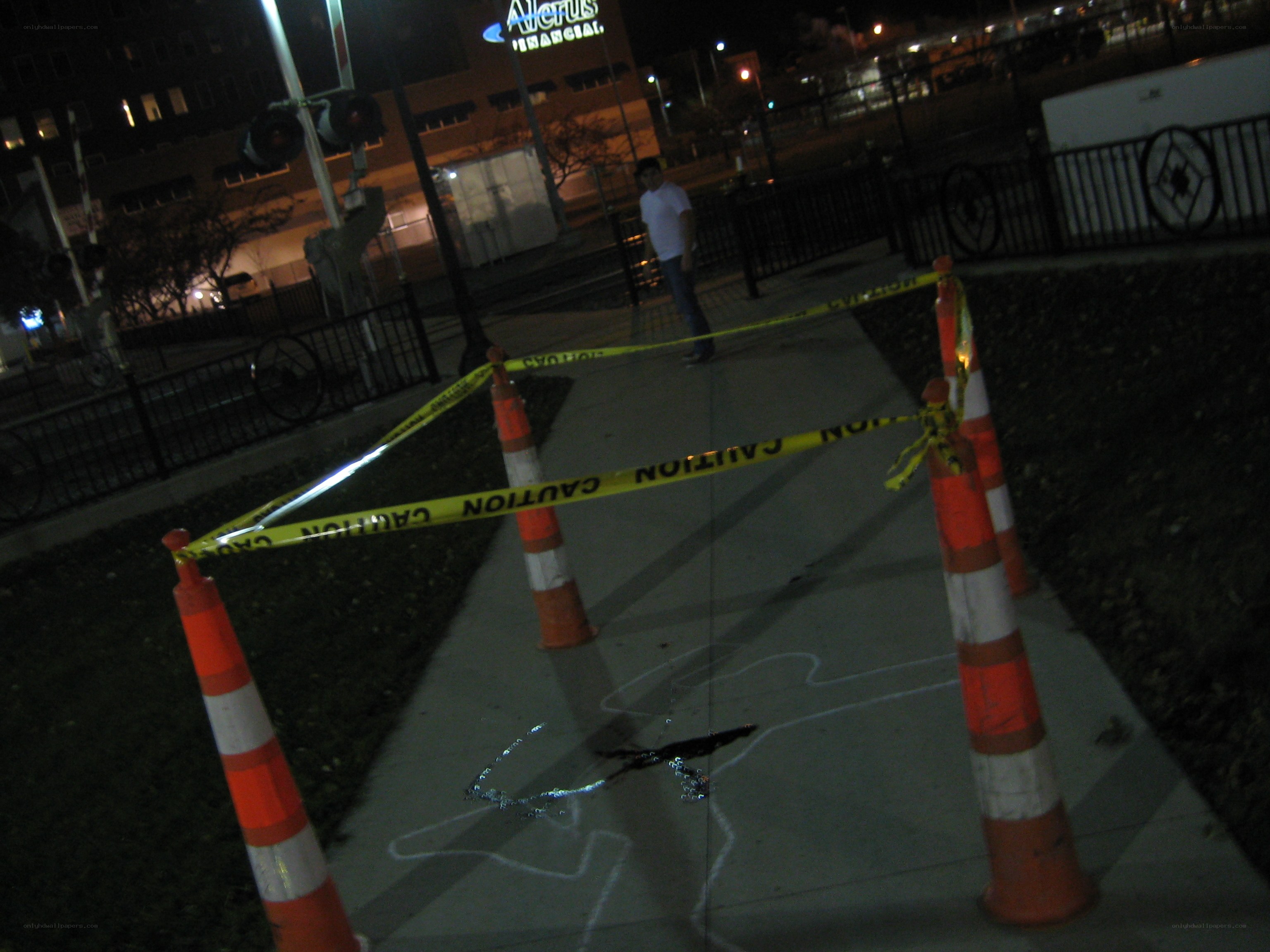 Crime scene tape on sidewalk