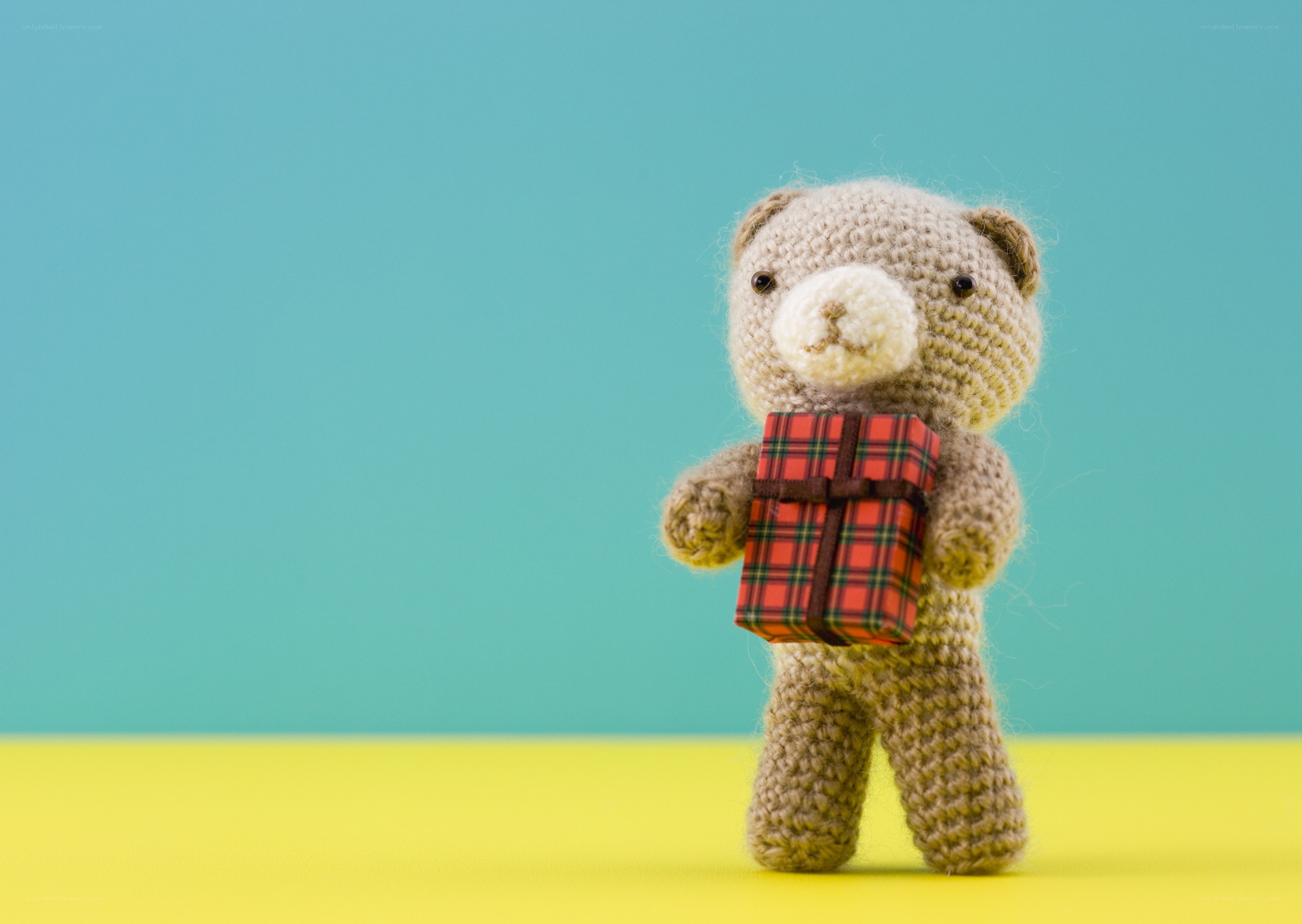crochet bear holding gift