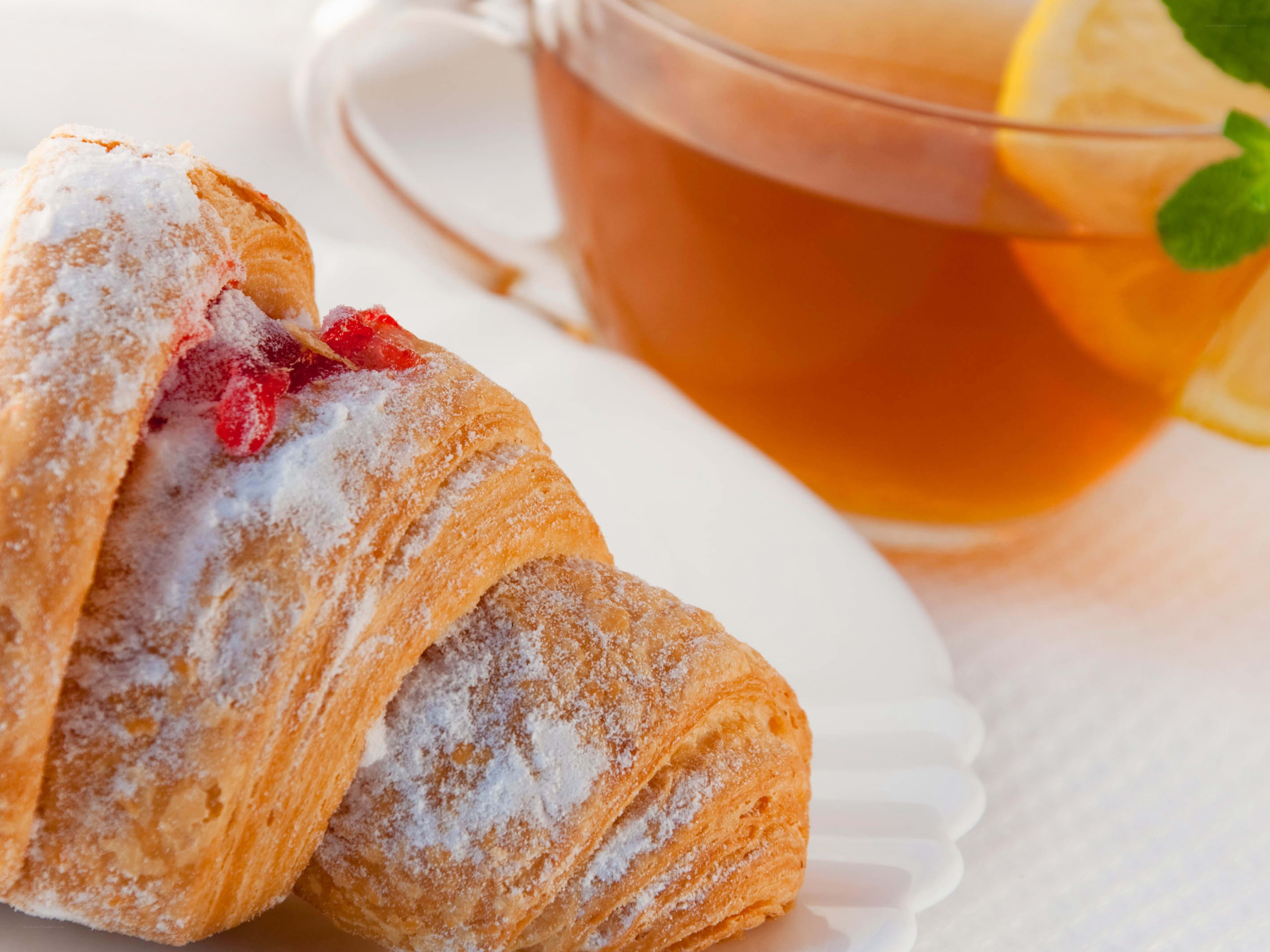 croissant and tea on white plate