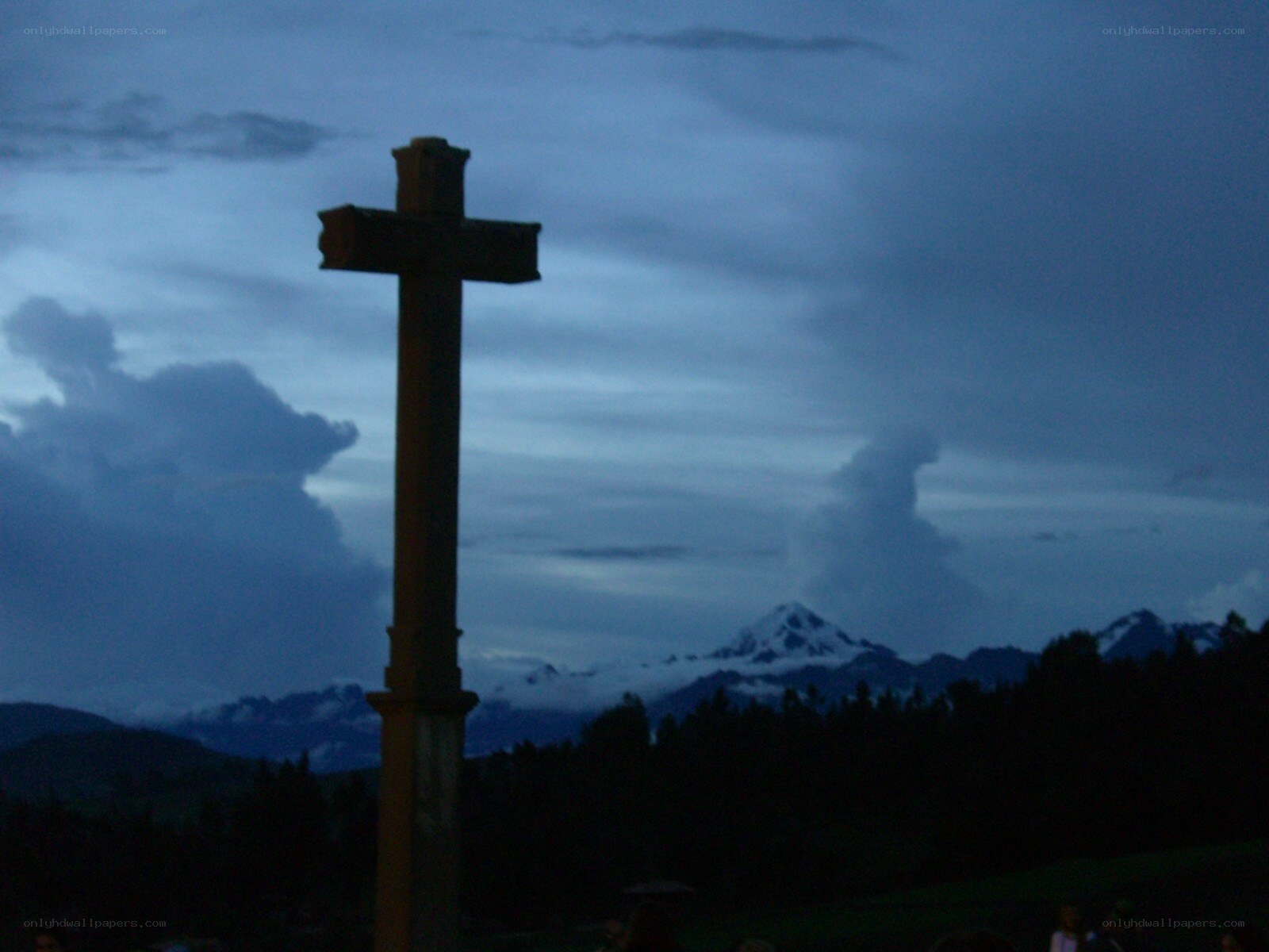 Cross against mountain backdrop