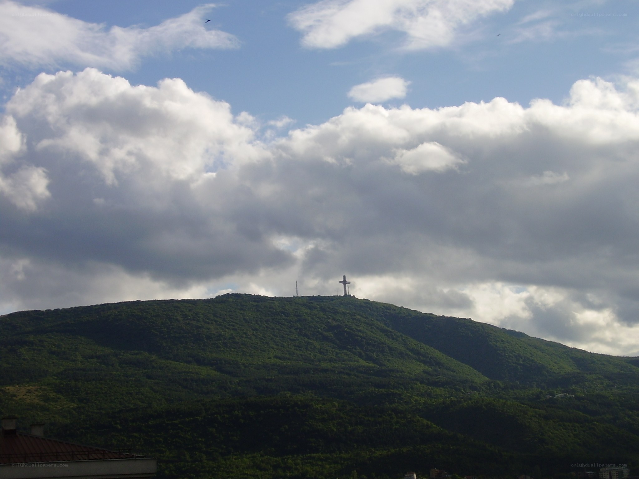 Cross on a green hill