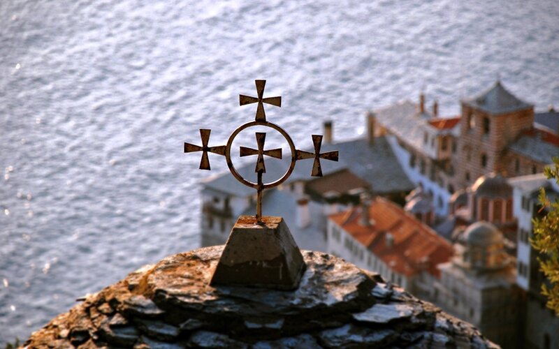 Cross overlooking coastal town