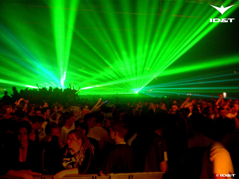 Crowd at a concert with green lasers