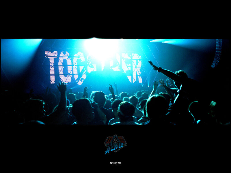 Crowd at a concert with 'TOGETHER' sign