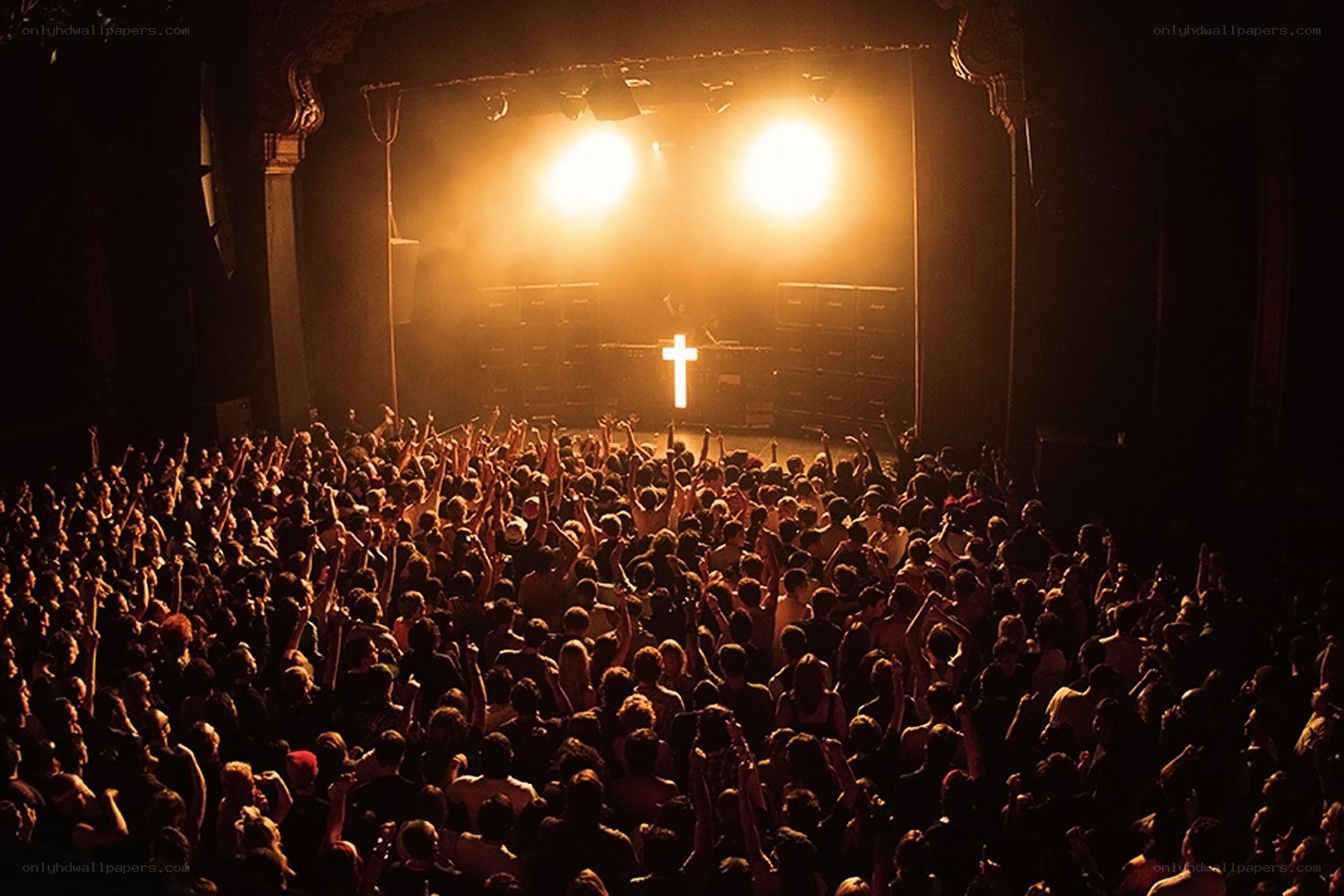crowd at concert with cross