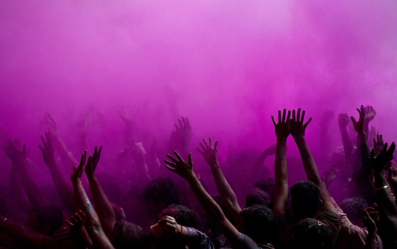 Crowd celebrating with purple powder