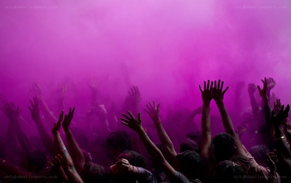 Crowd celebrating with purple powder