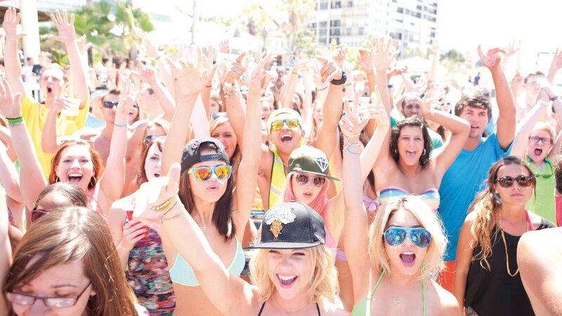 Crowd cheering at beach party