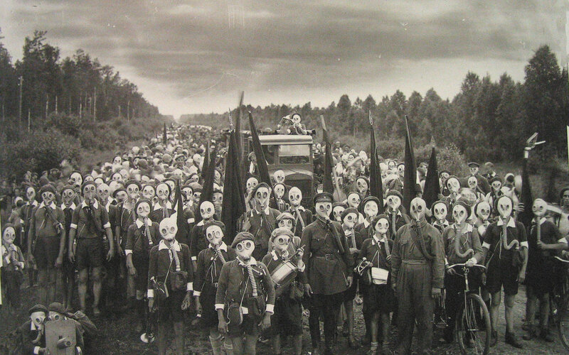 Crowd in gas masks on road