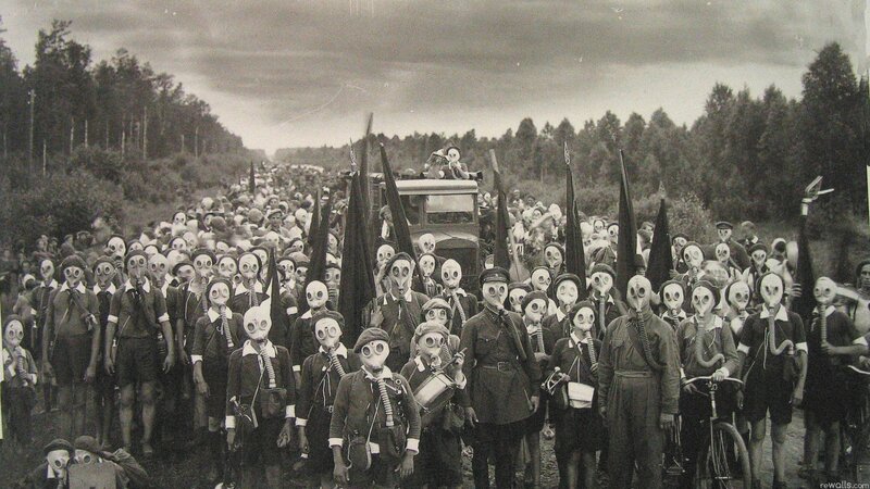 Crowd in gas masks on road