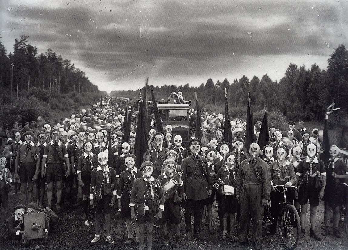 Crowd in gas masks on road