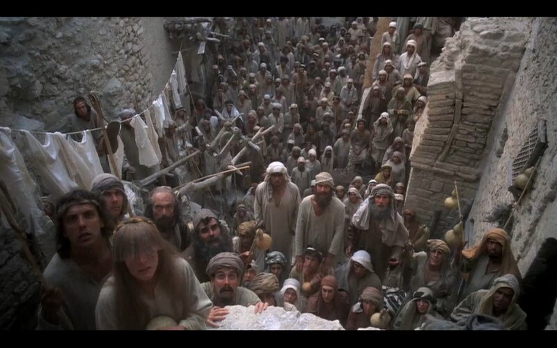 crowd in narrow alleyway