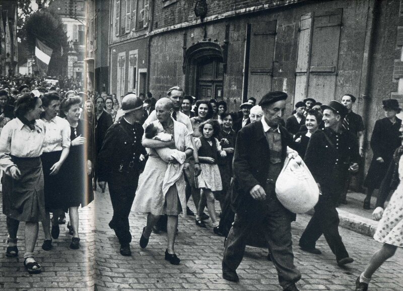 Crowd walking on cobblestone street