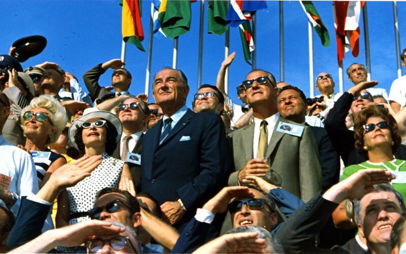 Crowd watching event under flags