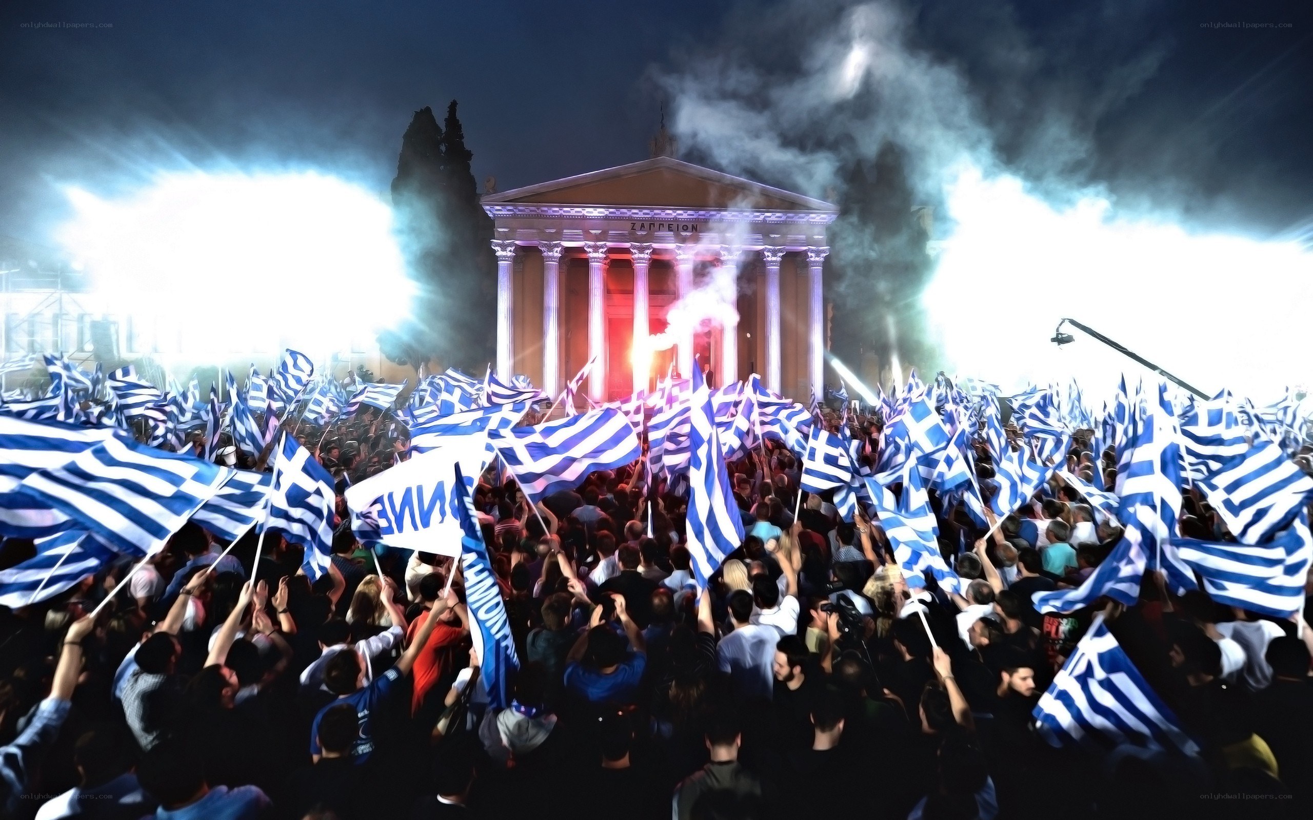 Crowd with Greek flags at night