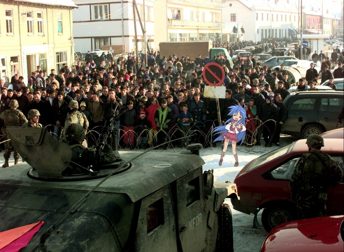 Crowd with military vehicles