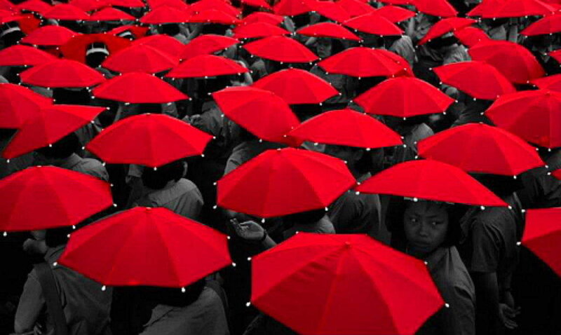 crowd with red umbrellas