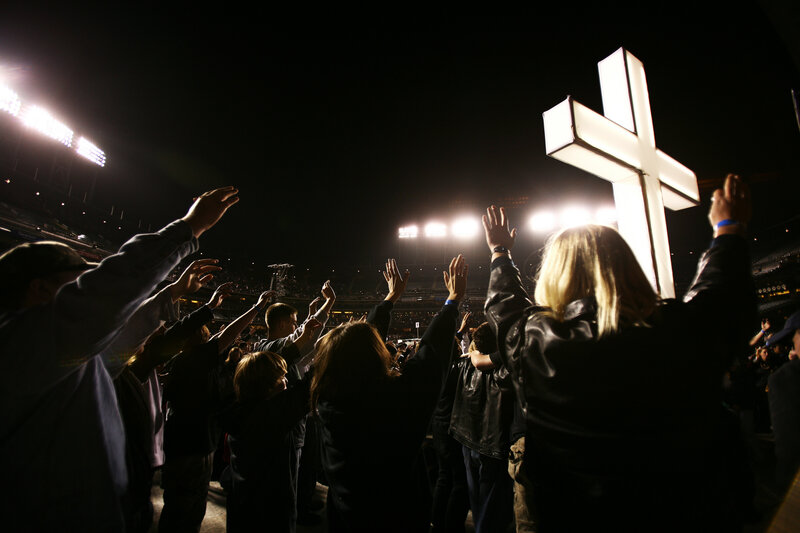 Crowd worshiping at night event