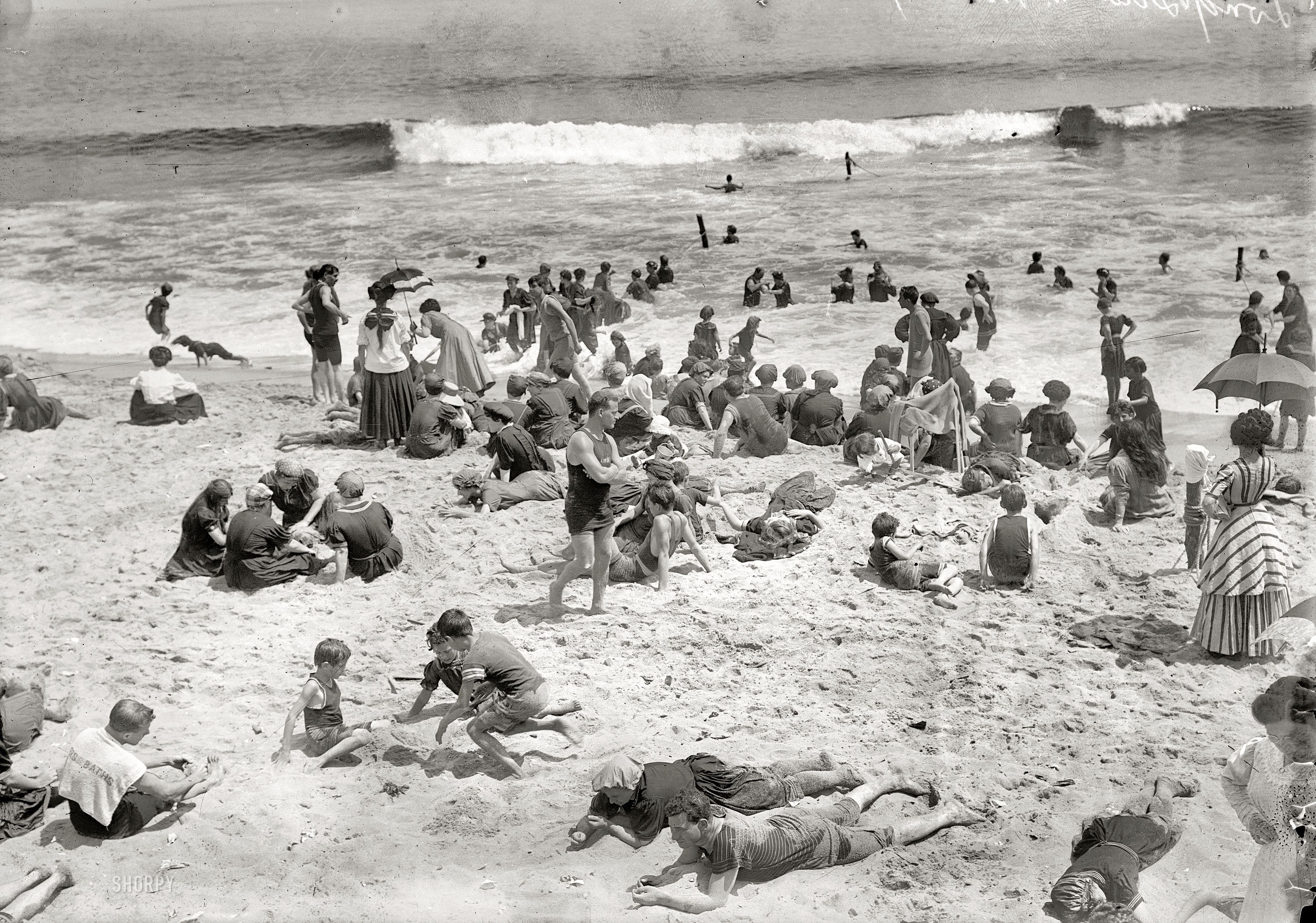 Crowded beach scene in black and white