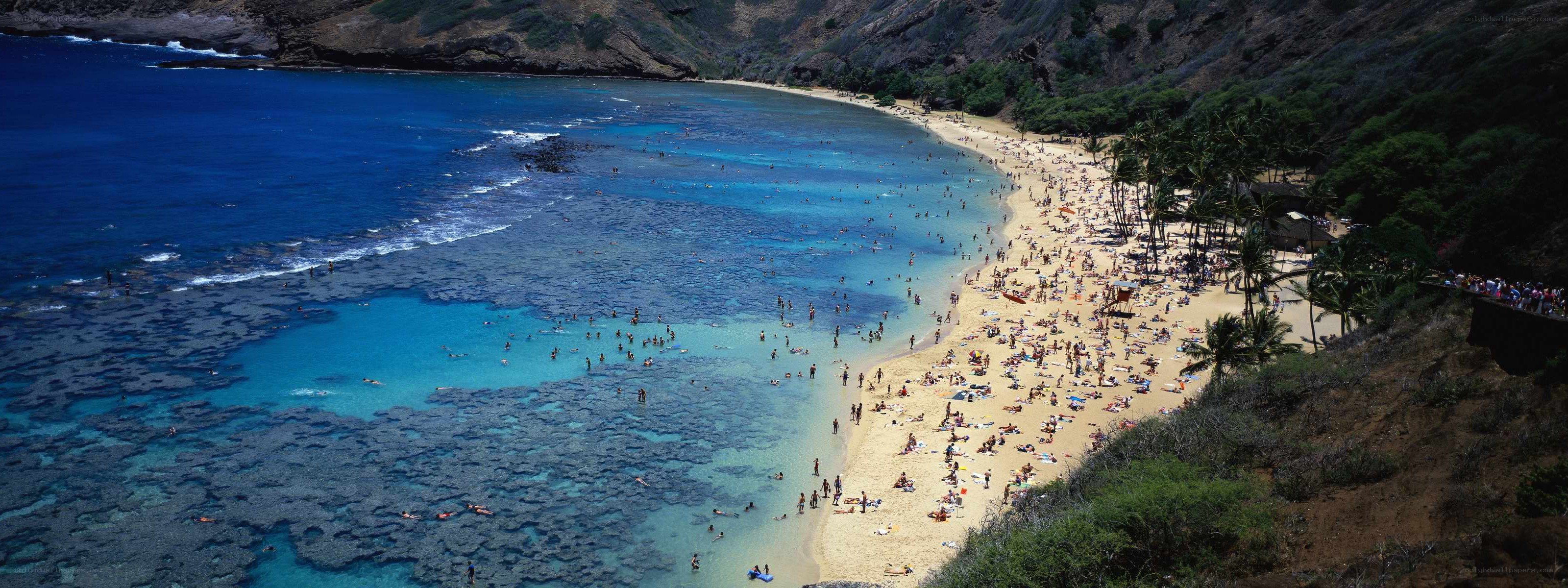 Crowded beach with clear blue water