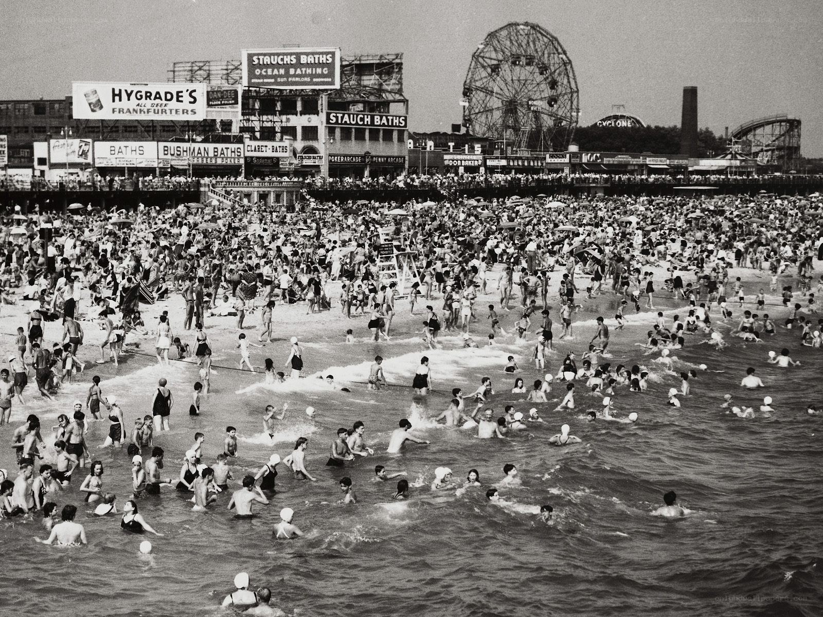 Crowded beach with Ferris wheel