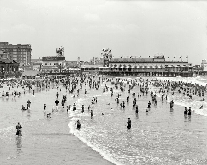 Crowded beach with pier
