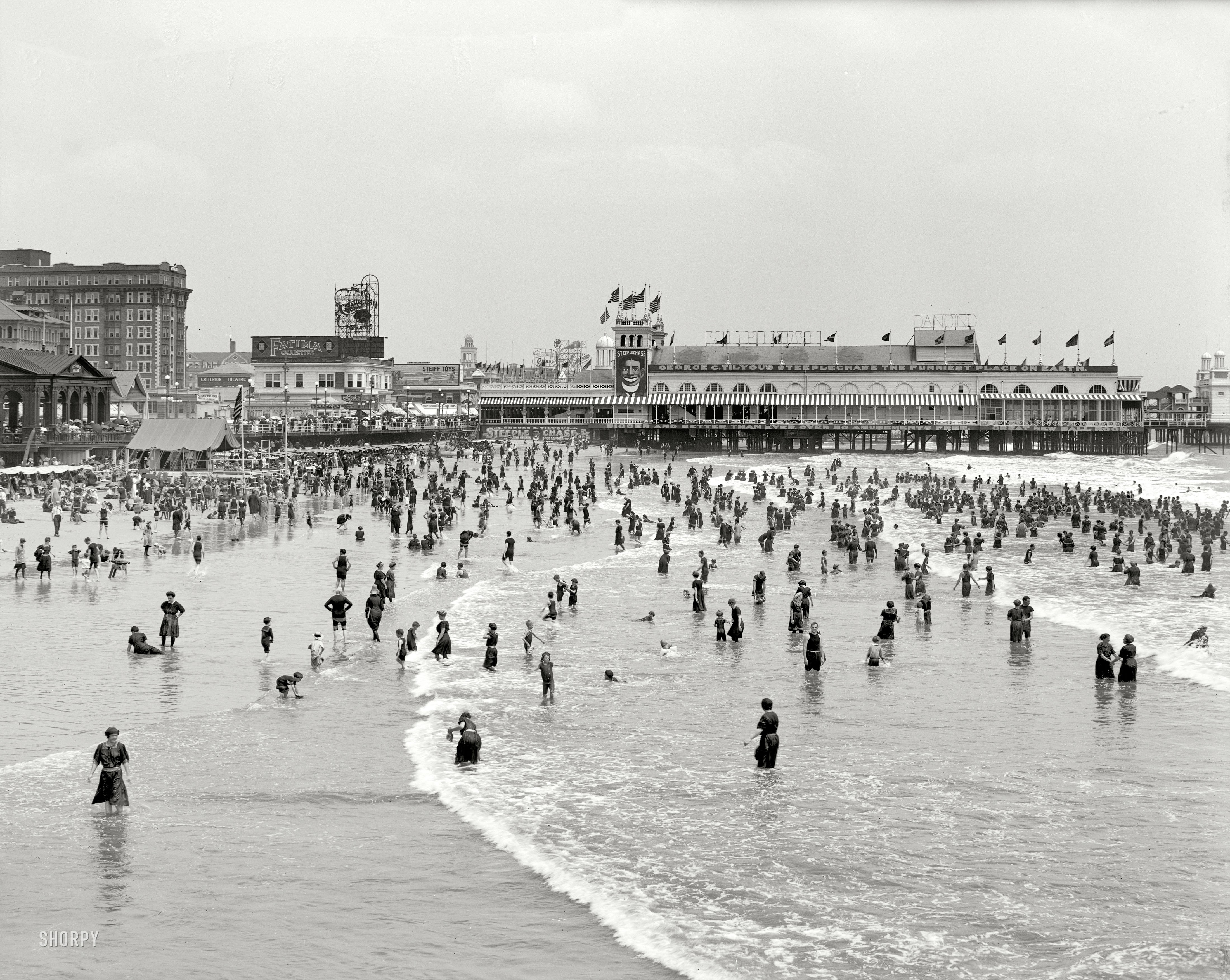 Crowded beach with pier