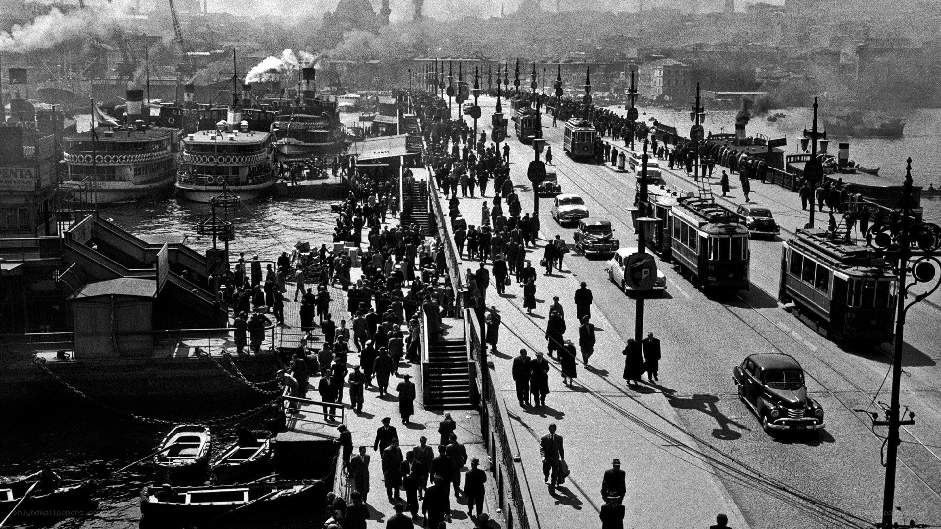 Crowded bridge with trams and boats