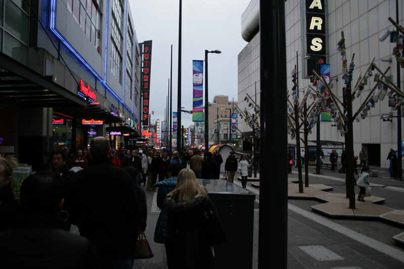 Crowded city street with neon signs